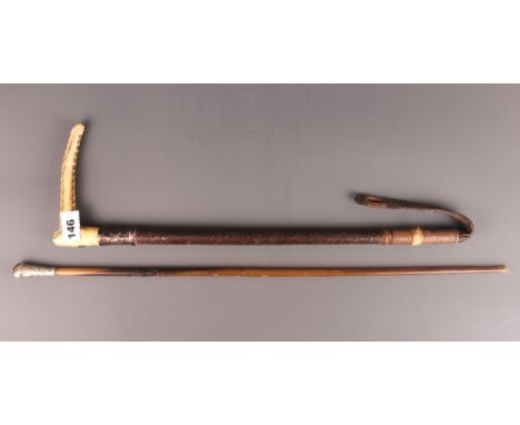 An antler and white metal handled riding crop and a white metal mounted swagger stick