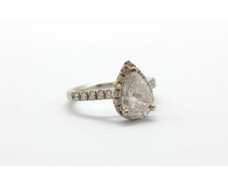 An 18ct white gold (stamped 750) ring set with a pear cut diamond surrounded by brilliant cut diamonds, approx. over 2ct cent