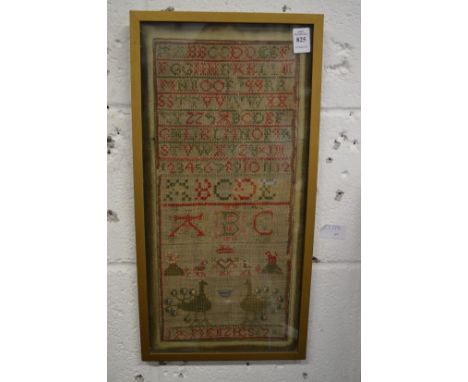 A sampler, probably 19th century, with alphabet, peacocks and other items, signed J A Menzies, 7.