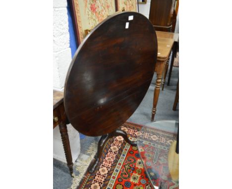 A 19th century mahogany tilt-top circular tripod table with bird cage action.