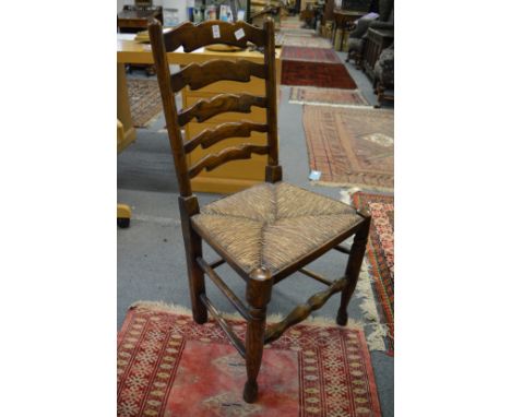 A set of six elm and rush seated ladder back dining chairs.