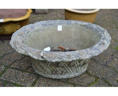 A reconstituted stoneware basket weave style planter and shallow bird bath.