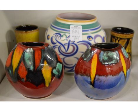 A pair of small Poole pottery volcano vases together with other Poole pottery vases.