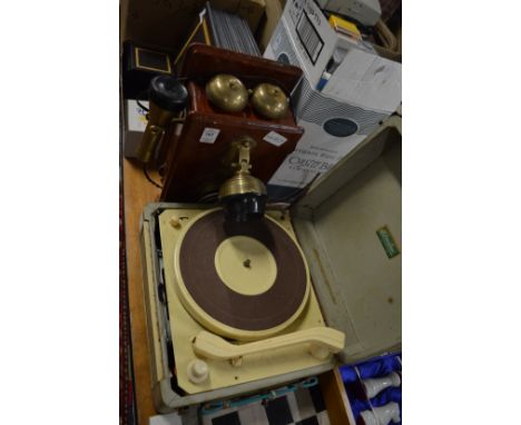 An old style wall mounted telephone and an early record player.