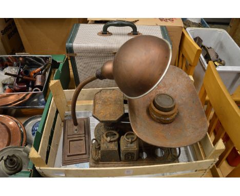 An old desk lamp, cast iron kitchen scales and weights and an early projector.