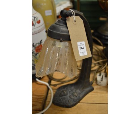 A stylish desk lamp and a brass table lamp.
