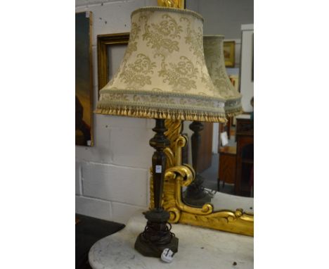 A large metal table lamp with shade.