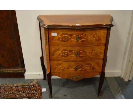A French design mahogany and marquetry decorated serpentine fronted three drawer petit commode.