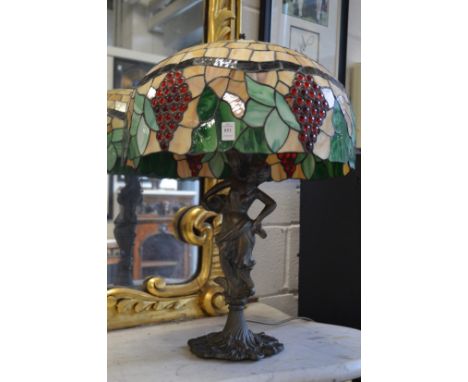 A large Art Nouveau style table lamp with stained glass shade.