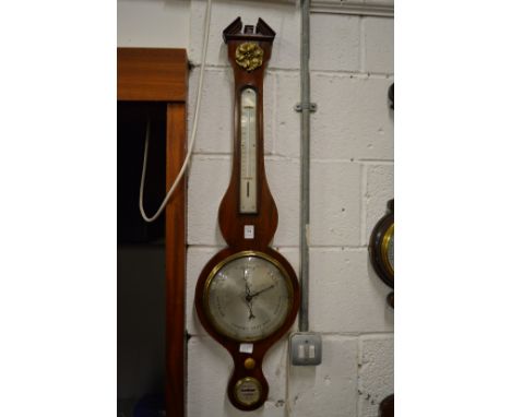 A mahogany cased barometer and thermometer.