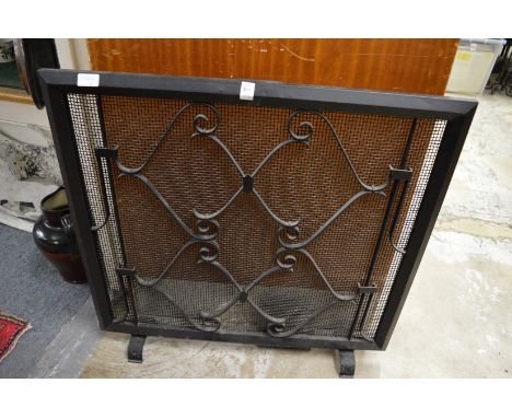 A wrought iron fire screen.