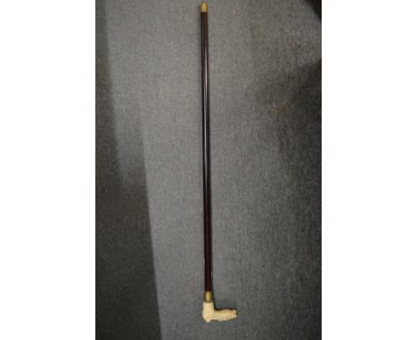 A bone handled walking stick, the handle modelled as a horse and jockey.