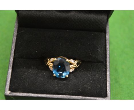 A gold and gem set ring.