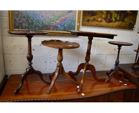 Four various mahogany tripod tables.