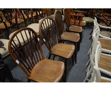 A set of four 19th century ash and elm stick back dining chairs.