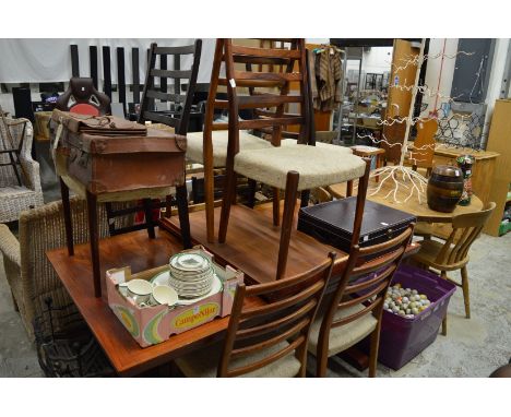 A stylish rectangular extending dining table with two leaves together with a set of eight matching ladder back dining chairs.