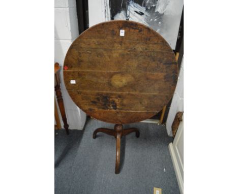 A 19th century oak circular tilt-top tripod table.