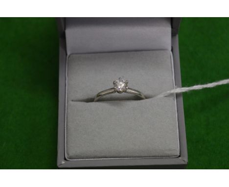 A platinum and diamond solitaire ring.