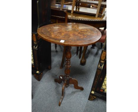 An inlaid walnut circular tripod table.