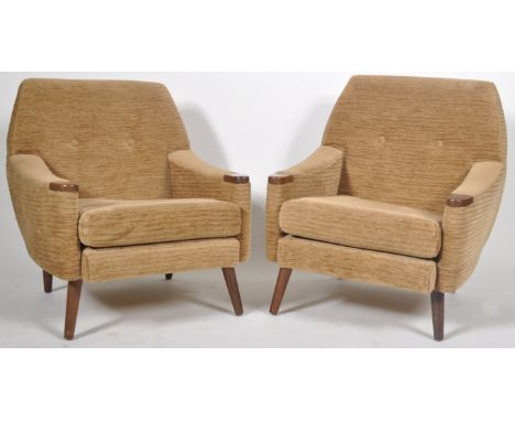 A pair of retro vintage 1960's easy lounge arm chairs / armchairs having cushioned button down backrests with shaped arms set
