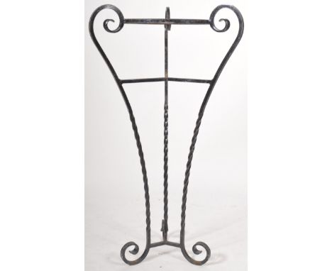 A retro vintage 20th Century wrought iron jardiniere planter stand comprising of three scrolled legs with central plant holde