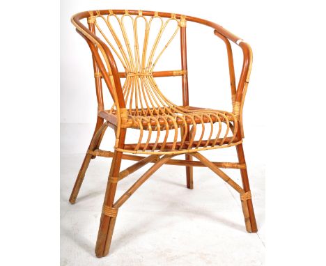 A retro vintage 20th Century Italian bamboo and wicker / cane armchair having a curved backrest with peacock form cane work w