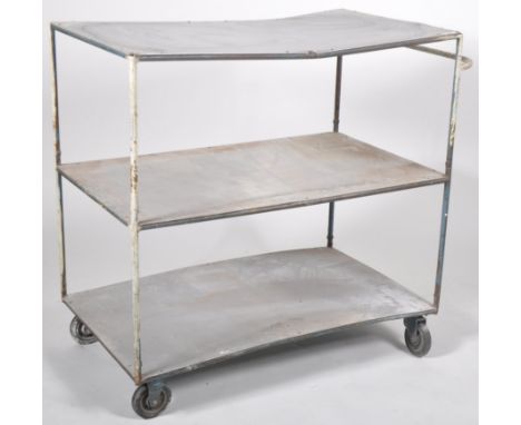 A retro vintage mid 20th Century believed Military used industrial trolley. Comprises of three tiers raised on tubular suppor