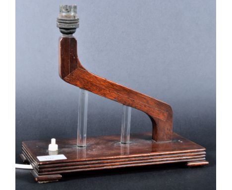 A vintage 20th Century Art Deco oak and glass table lamp light having an angular arm with fitting atop supported by two cylin