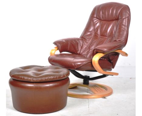A contemporary reclining swivel lounge chair / armchair having bent show wood armrests with stitched dark brown leather uphol