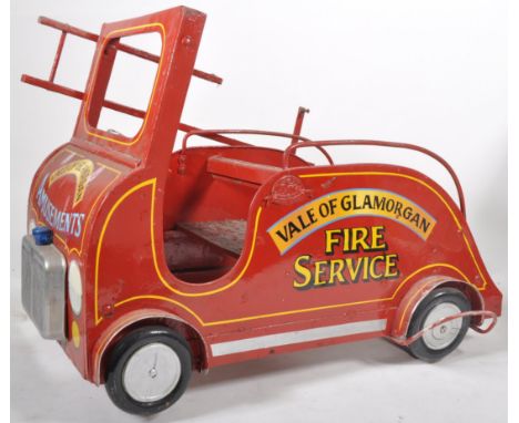 A retro vintage mid 20th Century fairground / funfair painted wood and metal carousel ride vehicle in the form of a fire engi