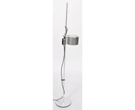 A retro 20th Century 1970's floor standing rise and fall spot lamp light having a polished aluminum drum shade raised on a si