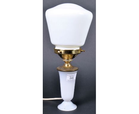 A vintage 20th Century Art Deco milk and opaline glass table lamp light having shaped milk glass shade supported by a brass g