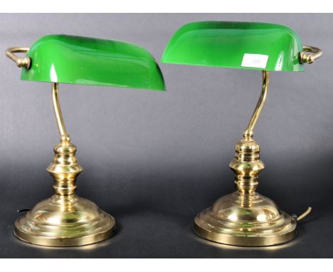 A pair of vintage late 20th Century English bankers desk / table lamp lights of brass construction. Each having an adjustable