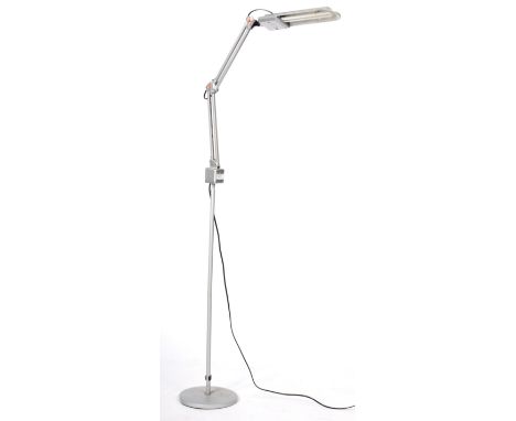 A retro vintage late 20th Century German floor standing lamp comprising of an elongated anglepoise type light top raised on t