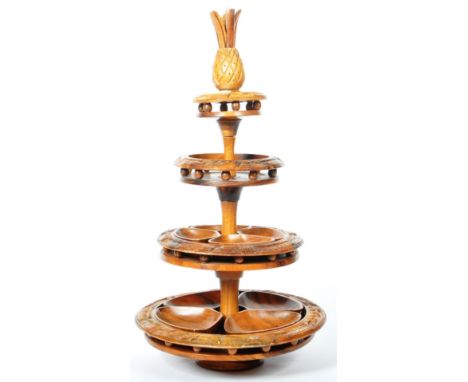 A large retro vintage mid 20th century carved wooden Tiki multi tier Lazy Susan buffet / serving stand comprising of a carved