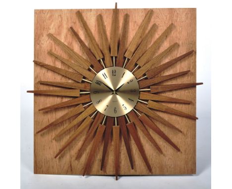 After George Nelson - Star Clock - A contemporary star shaped wall clock. The clock comprising of walnut wood and brass starb