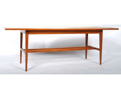 A retro vintage mid 20th Century large Long John teak coffee table having a rectangular top raised on four slender tapering s