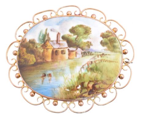 An early 20th century brooch, the oval painted ceramic plaque depicting a rural scene, within an openwork surround, marks for