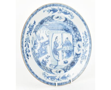 A Qing dynasty blue and white ceramic charger plate. The ogee charger plate depicting a scene of a couple in the pavilion sur