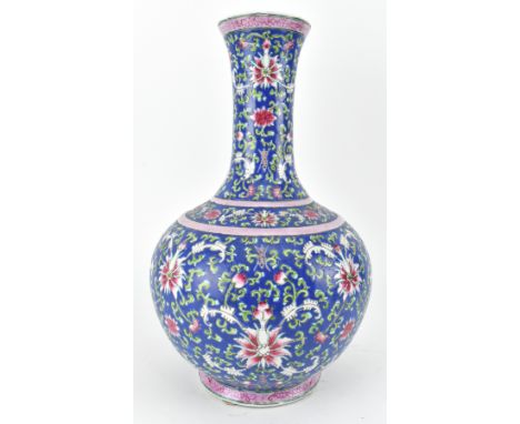 A Chinse ceramic famille rose bottle vase - tiaqiuping. The bulbous shaped vase having a blue ground with passion flowers, fl