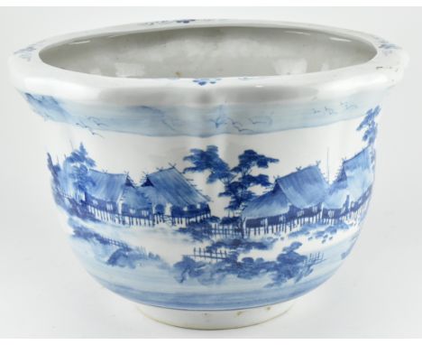 A large19th/20th century blue and white ceramic jardini&egrave;re planter. The lettuce flatten rim ovoid form jardini&egrave;