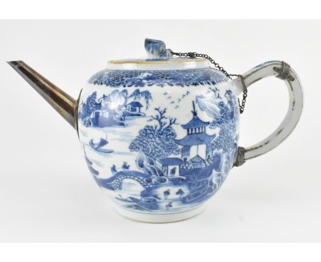 A Qing dynasty Kangxi period blue and white teapot. The ovoid form tea pot with metal spout decorated with landscapes, houses