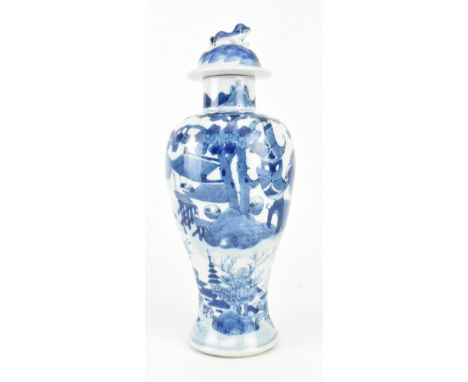 A Qing dynasty blue and white meiping vase with cover. The baluster shaped meiping vase decorated mountains on the neck, hous