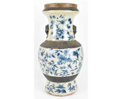 A Qing dynasty possibly Xianfeng period crackle glazed Nanking blue and white ceramic vase. The baluster flanked with two lio