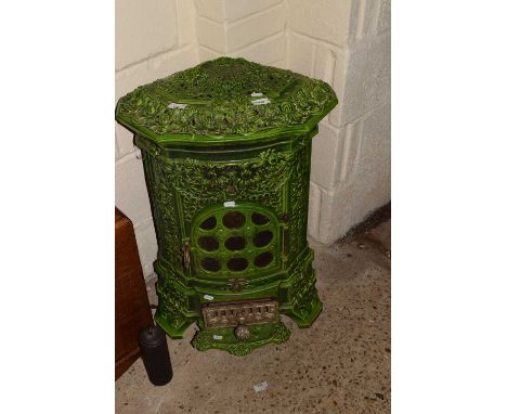 A decorative continental green enamel finish stove with pierced floral decoration