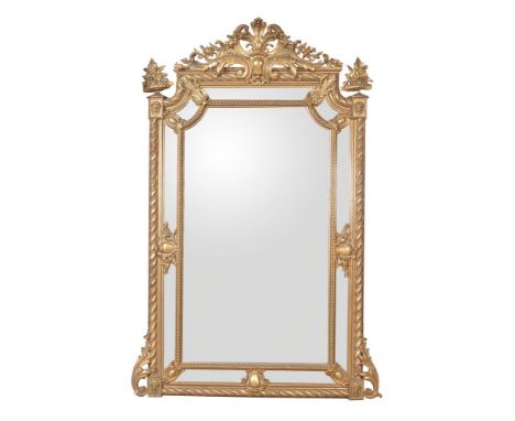 A Peruvian giltwood and gesso pier mirror in Napoleon III style, circa 1875, the pierced foliate scroll cresting centred by a