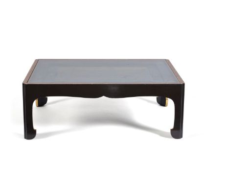 A black lacquered and parcel gilt low centre table, 20th century, the glazed top enclosing a central lacquer panel, with butt