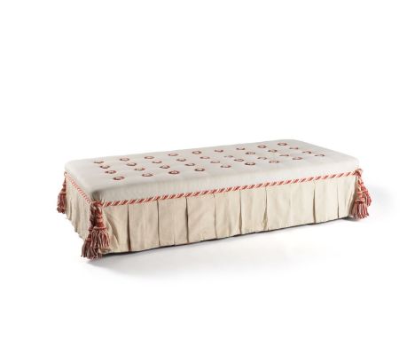 A rectangular cream button upholstered centre footstool, late 20th century, with tassels to each corner, 35cm high, the top 1