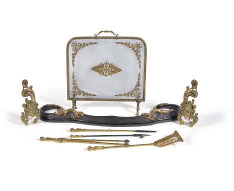 An associated suite of brass and iron mounted fireplace furniture, 19th century, comprising a rectangular mesh fire screen wi