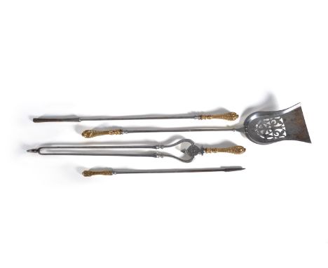 A set of three early Victorian steel and brass mounted fire tools in Rococo Revival taste, mid 19th century, comprising a tul